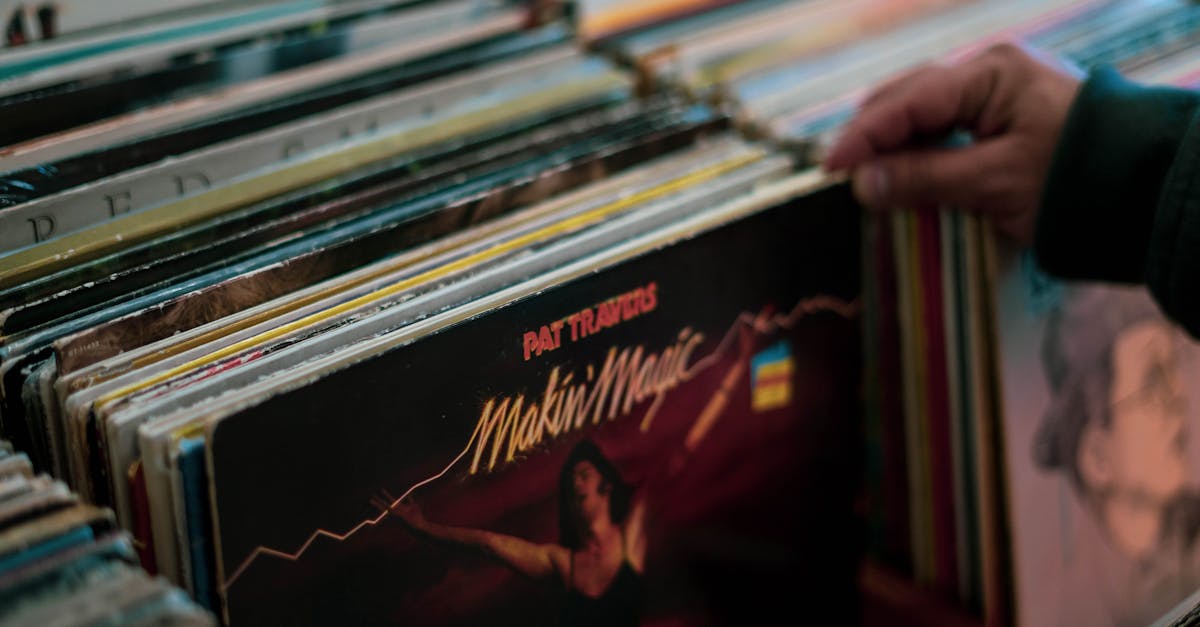 Person browsing vinyl records collection in a Cambridge store. Nostalgic and retro vibe.