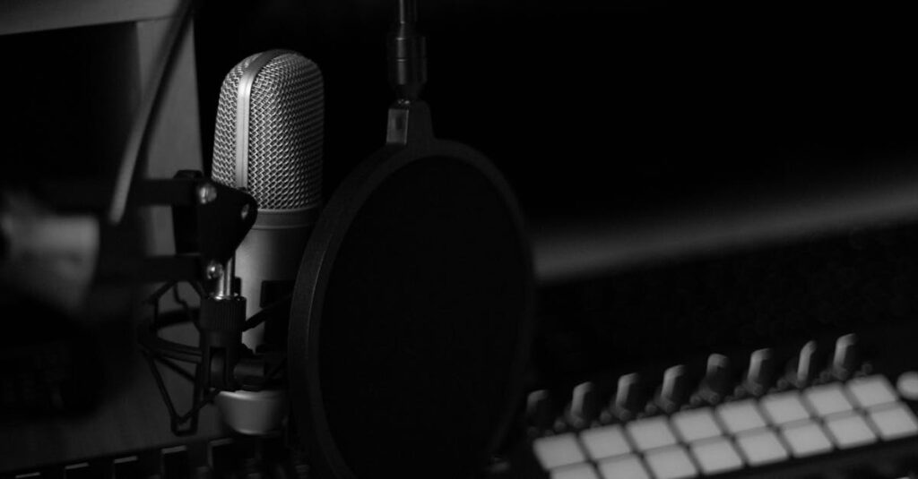 Elegant black and white image of a music studio with a microphone and synthesizer keyboard.