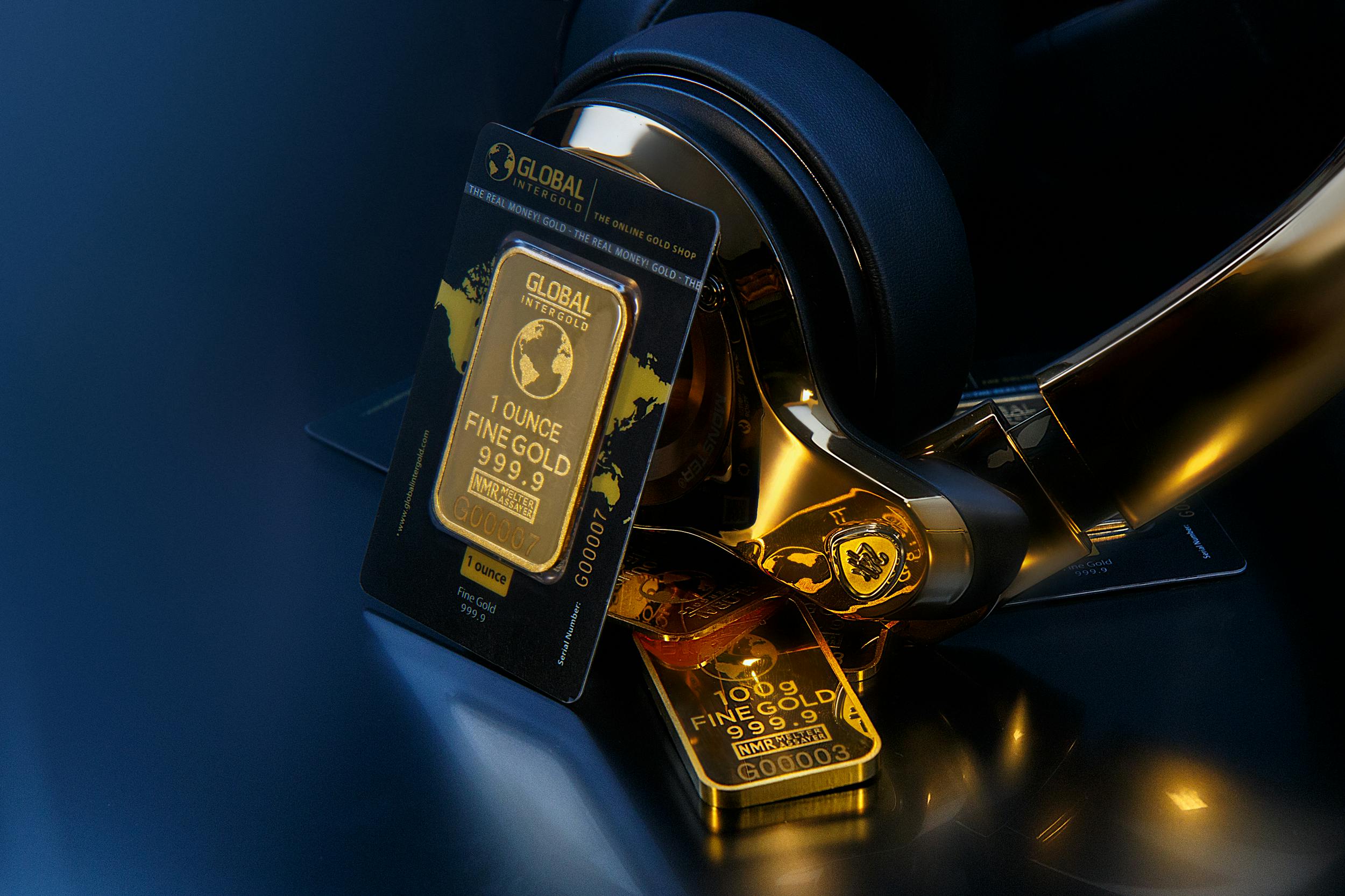 Elegant image of gold bars paired with sleek gold headphones, symbolizing wealth and luxury.